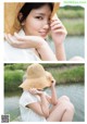 A woman in a straw hat sitting by the water.